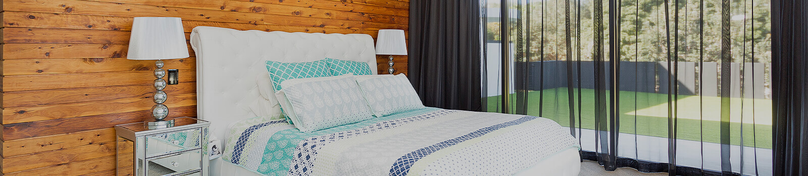Bedroom surrounded by large glass windows