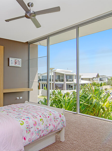 View from child's bedroom to street through floor to ceiling windows