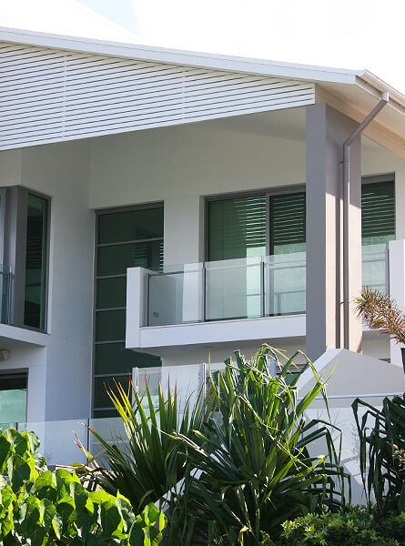 Beach house with glass windows, doors and fencing